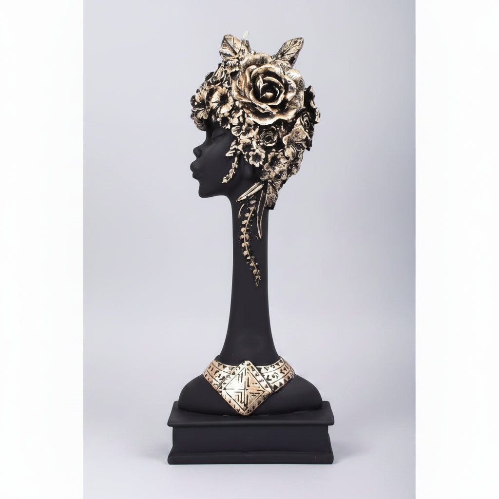 A figurine of an African lady made from resin, featuring intricate details and a floral headdress.