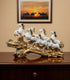 Aurance white and gold resin 7 running horses statue, a luxury Vastu decorative showpiece for home and office decor.
