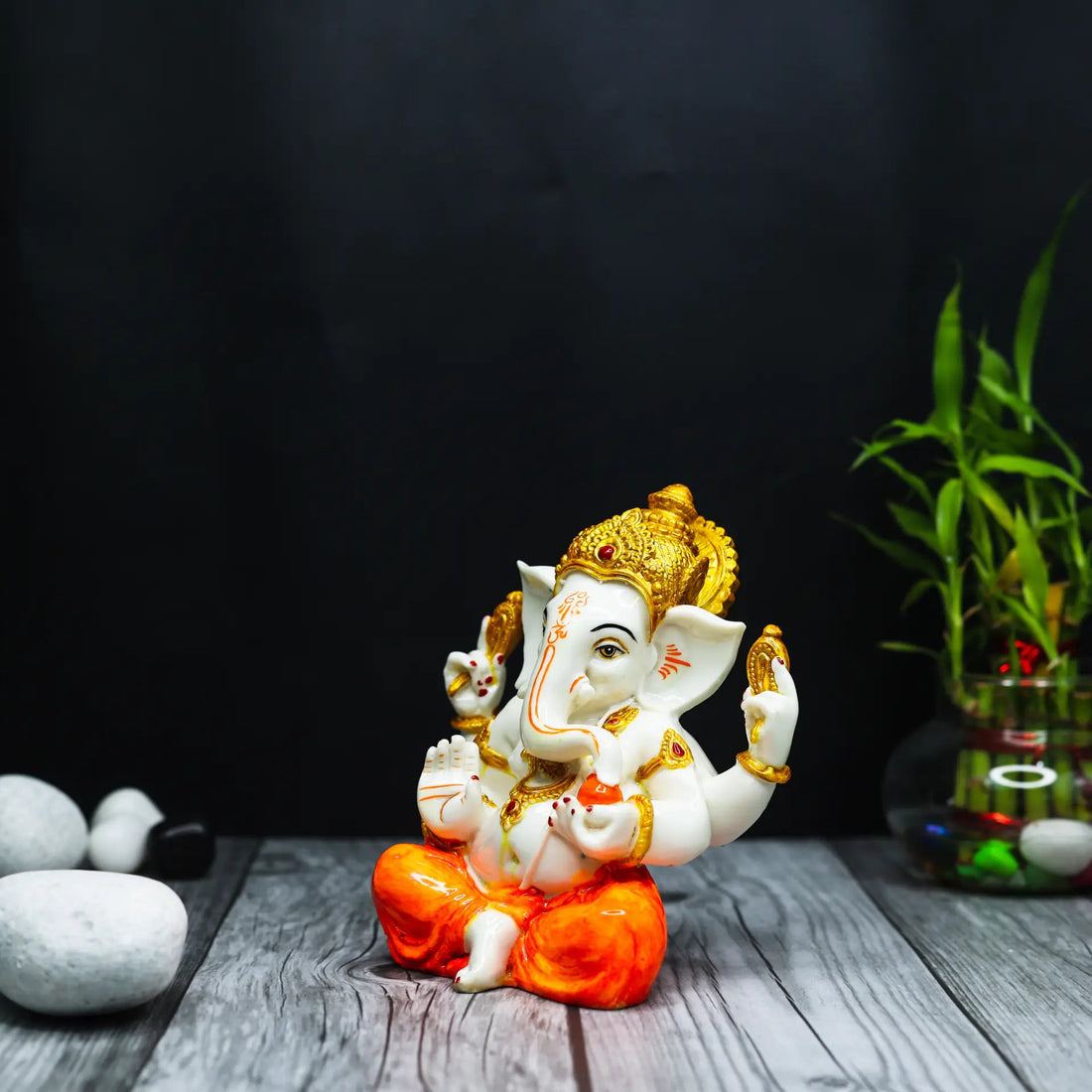Aurance Ganesha idol with white skin and orange dhoti, featuring gold detailing, perfect for home or car decor.