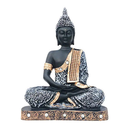 Aurance grey and black resin meditating Buddha statue with gold accents and decorative stone detailing.