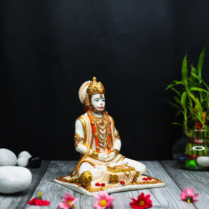Aurance Lord Hanuman sitting statue in a meditative pose, reading a book with a gada, featuring gold and white detail.