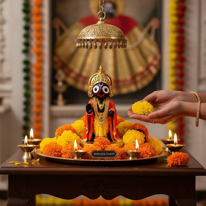 Aurance handcrafted resin Lord Jagannath statue with marble finish, surrounded by marigold flowers and lit diyas.