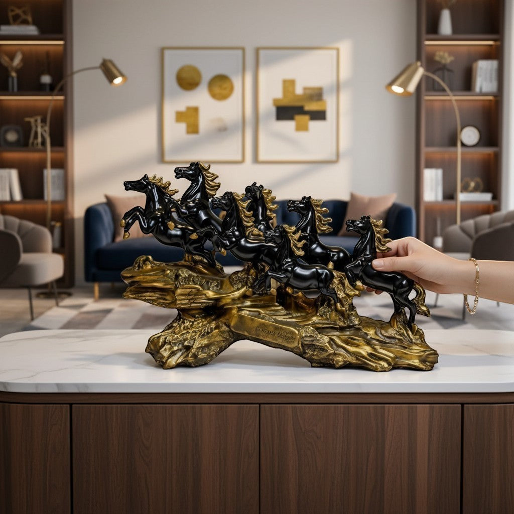 Aurance running horses tabletop sculpture with polished black horses on a textured antique gold base in a living room.