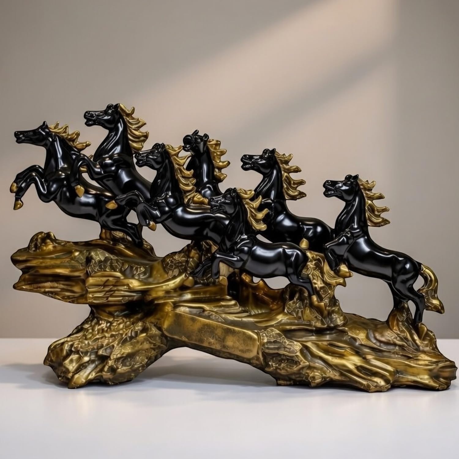 Aurance running horses tabletop sculpture with polished black figures on a textured antique gold base.